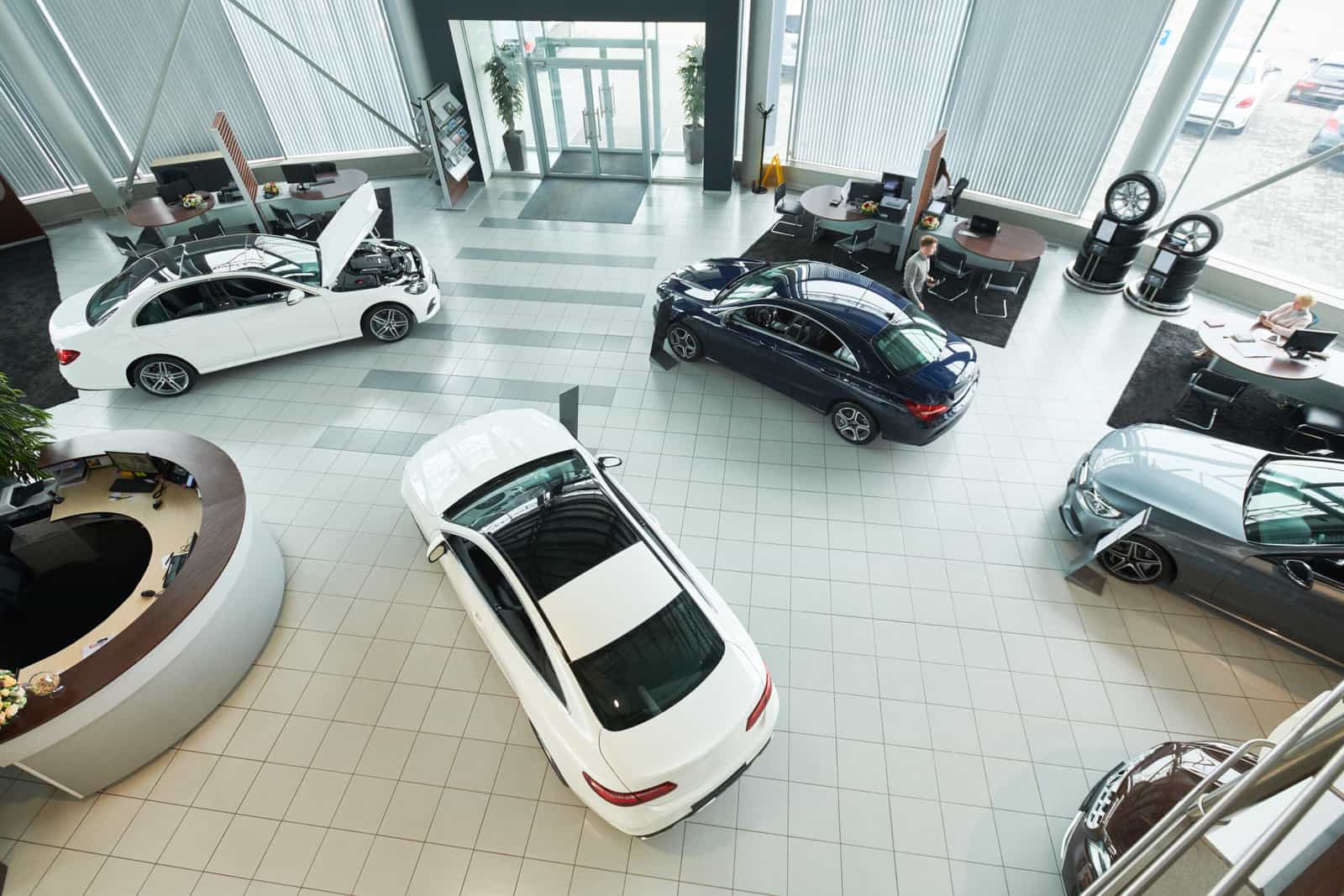Dealership showroom floor with several cars