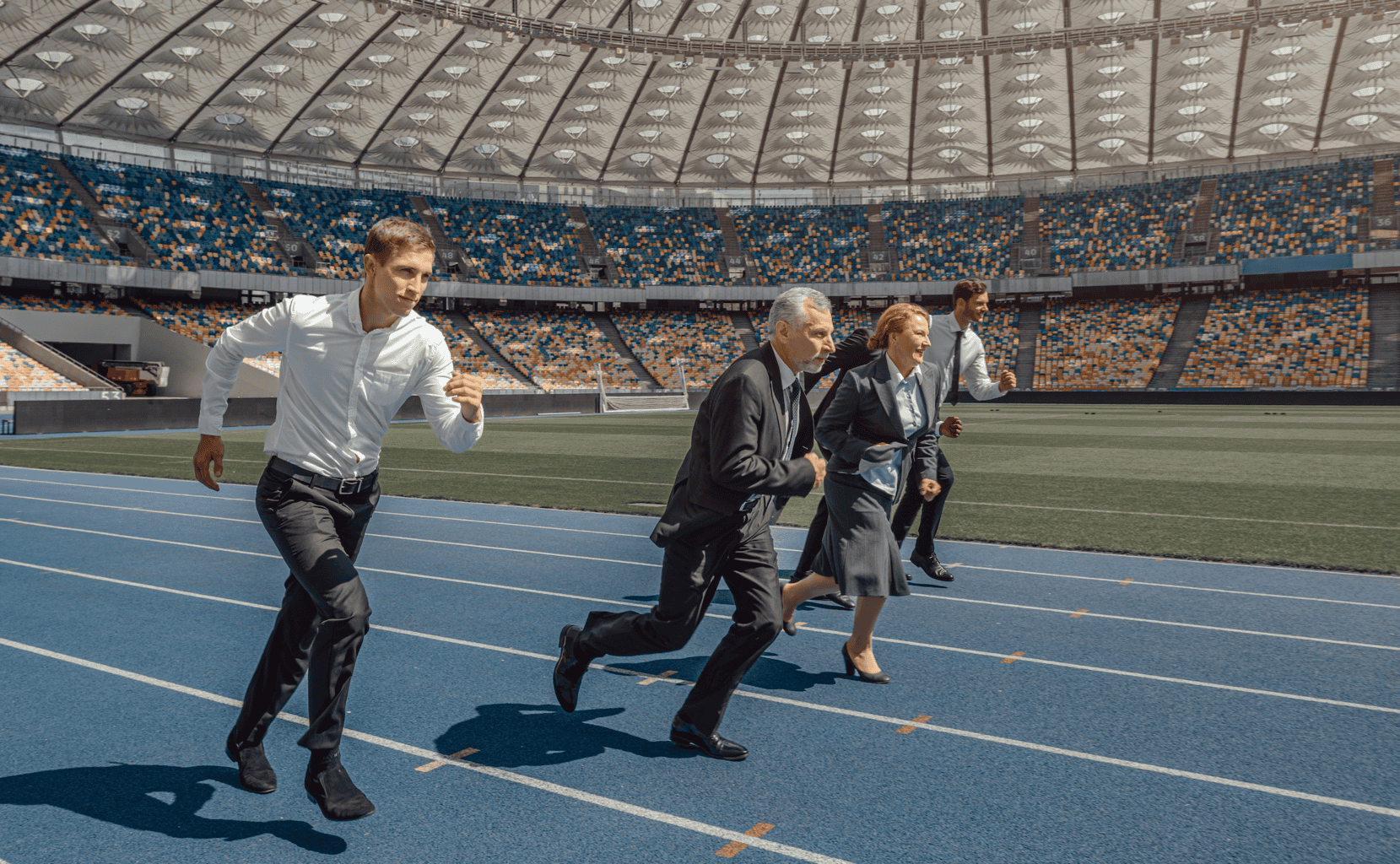 People in business attire running on a track